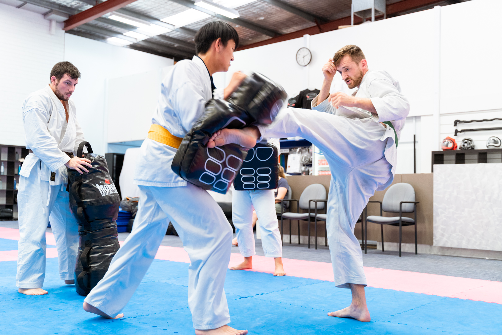 Male martial artist practicing kickboxing on the bag
